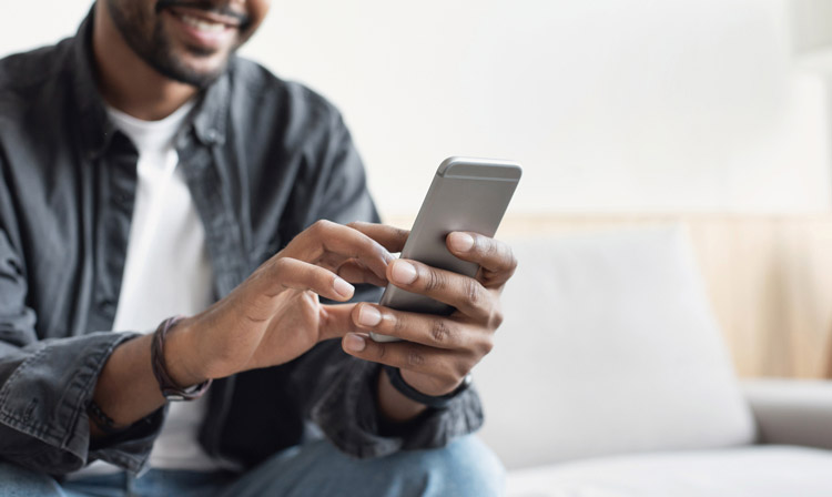 man using smart phone at home