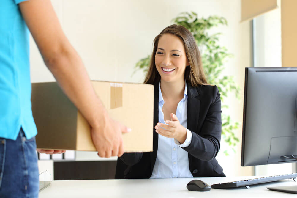 A girl receiving a box from delivery boy