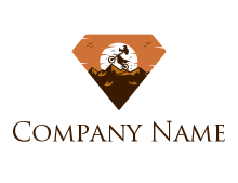 biker doing tricks on mountains in diamond shape logo