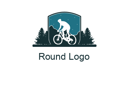 mountain biking in shield with trees emblem logo