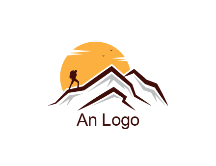 sun behind hiker on mountain