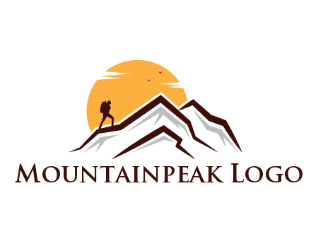sun behind hiker on mountain