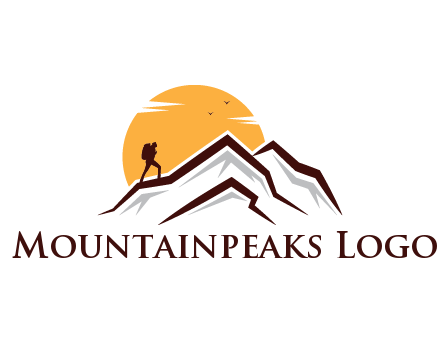 sun behind hiker on mountain