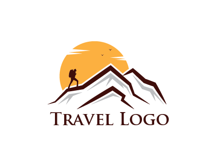 sun behind hiker on mountain